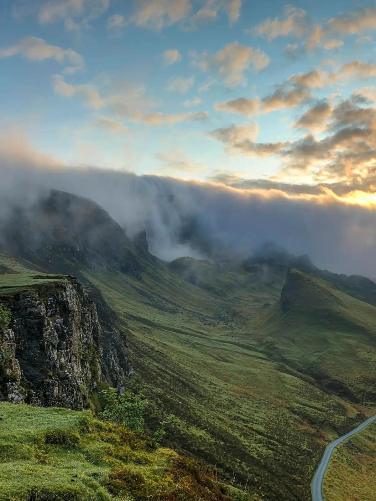 Layered forested ridges fading into morning haze, seen from a high viewpoint