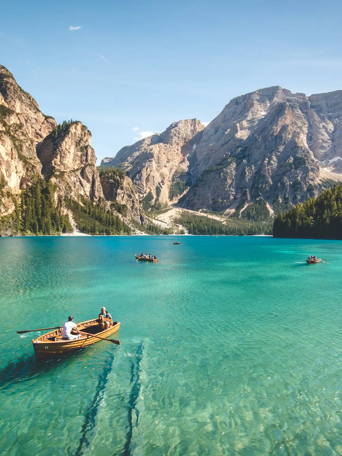 A still mountain lake with forested slopes coming down to the water on both sides